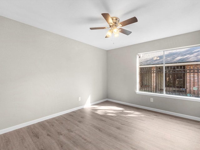 spare room featuring light hardwood / wood-style flooring, a wealth of natural light, and ceiling fan