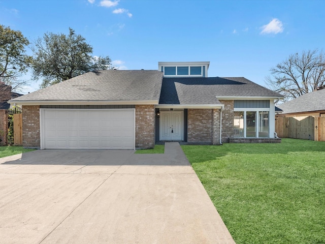 view of front of property with a front yard and a garage