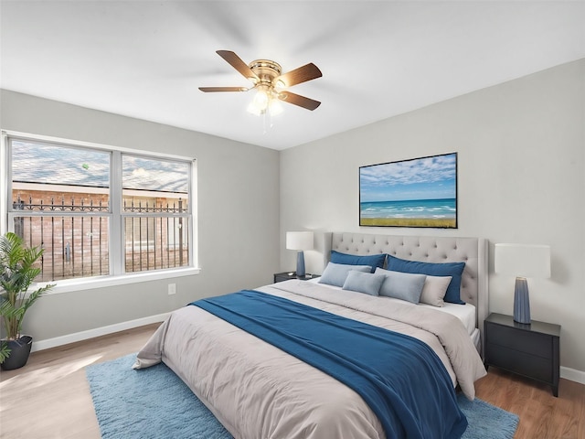 bedroom with hardwood / wood-style floors and ceiling fan