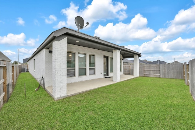 back of property with a patio and a lawn