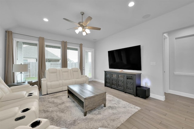 living room featuring ceiling fan and light hardwood / wood-style floors