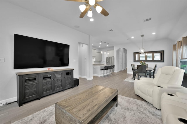 living room featuring ceiling fan and light wood-type flooring