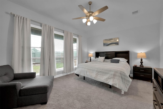 bedroom with carpet, multiple windows, and ceiling fan