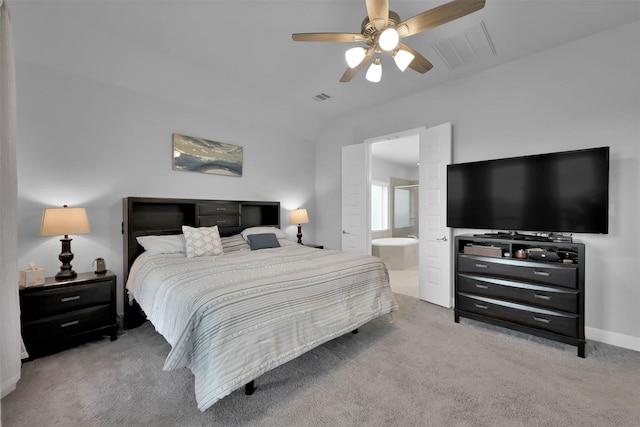 carpeted bedroom featuring ceiling fan and ensuite bathroom