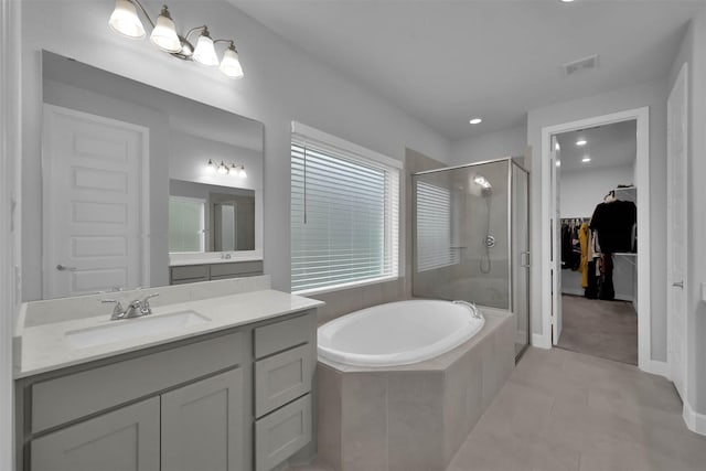 bathroom featuring tile patterned flooring, vanity, and independent shower and bath