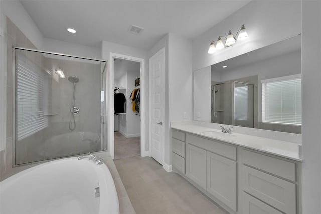 bathroom with tile patterned floors, vanity, and separate shower and tub