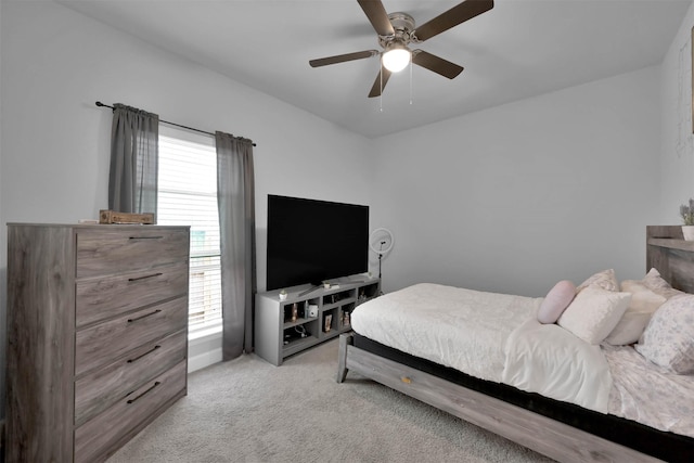 bedroom featuring ceiling fan and light carpet