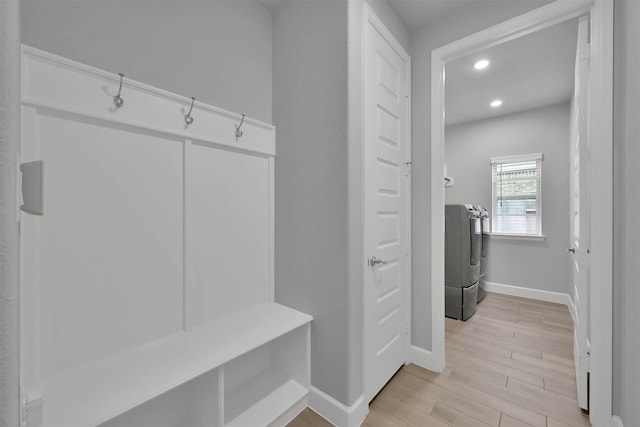 mudroom featuring light hardwood / wood-style floors and washer and clothes dryer