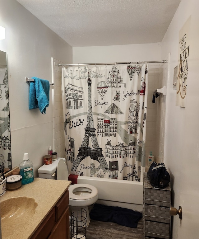 full bathroom featuring vanity, shower / bathtub combination with curtain, a textured ceiling, and toilet