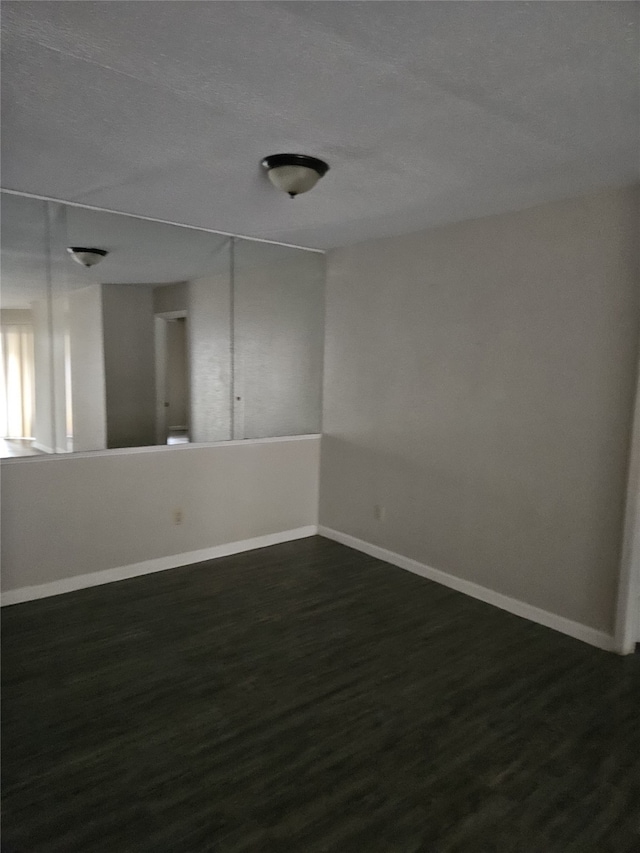 empty room featuring dark hardwood / wood-style floors