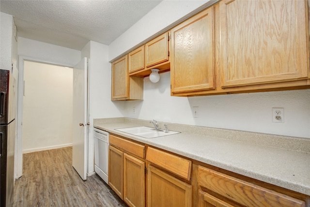 9797 Leawood Blvd Unit 903, Houston, TX 77099 - kitchen featuring white dishwasher, light wood-style floors, a sink, light countertops, and a textured ceiling
