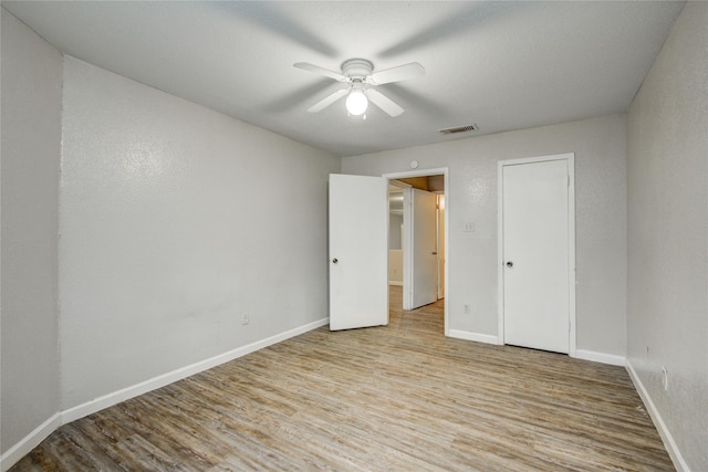 9797 Leawood Blvd Unit 903, Houston, TX 77099 - unfurnished bedroom with wood finished floors, baseboards, and a ceiling fan