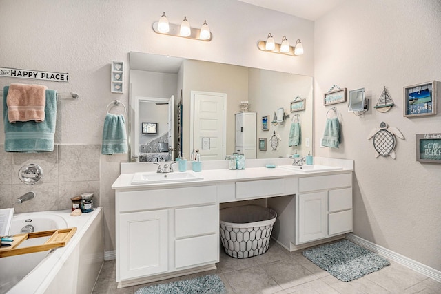 bathroom with vanity, tile patterned floors, and a bathing tub