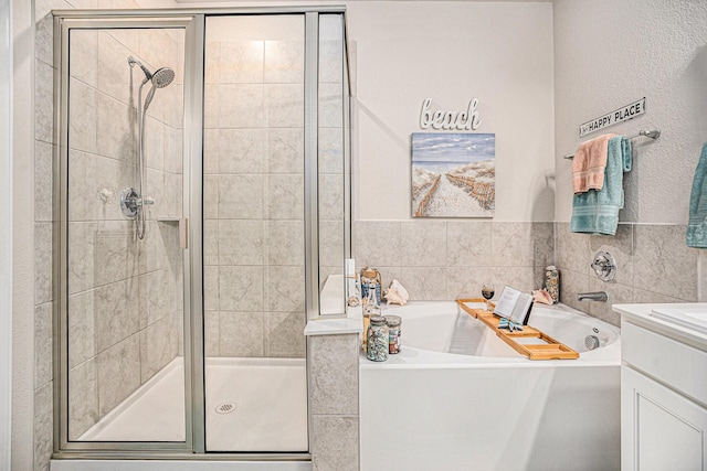 bathroom with vanity and independent shower and bath