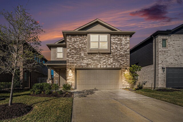 front of property with a garage and a lawn