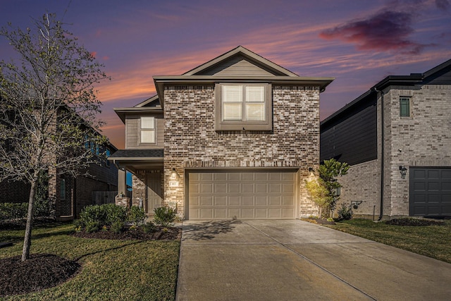 traditional-style home featuring an attached garage, brick siding, driveway, and a yard