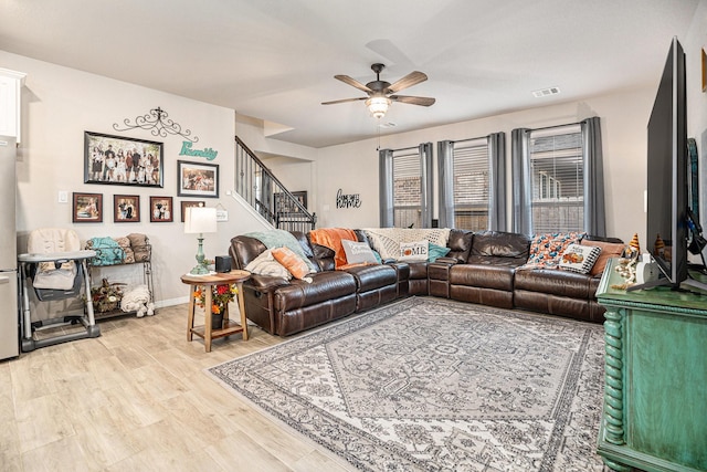 living room with ceiling fan and light hardwood / wood-style floors