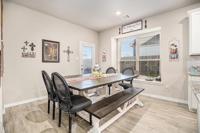 dining space with light hardwood / wood-style flooring