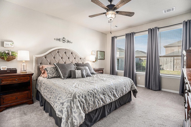 bedroom with a ceiling fan, light carpet, visible vents, and baseboards