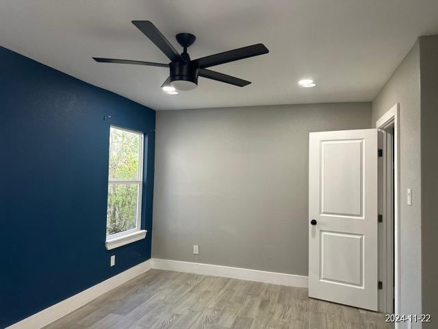 spare room with ceiling fan and light hardwood / wood-style flooring