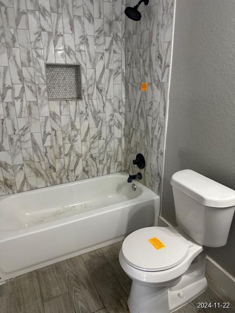 bathroom with toilet and tub / shower combination