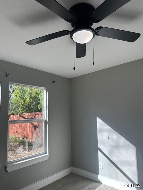 spare room featuring ceiling fan and wood-type flooring