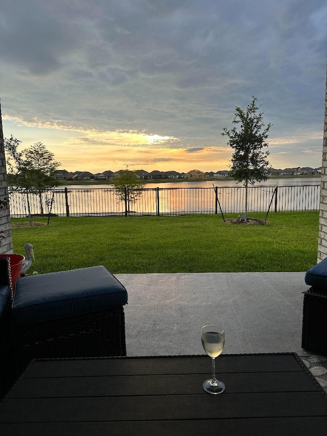 yard at dusk with a water view