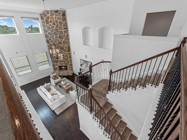 stairs featuring a fireplace and hardwood / wood-style floors