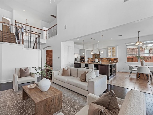 living room with a high ceiling and light hardwood / wood-style floors