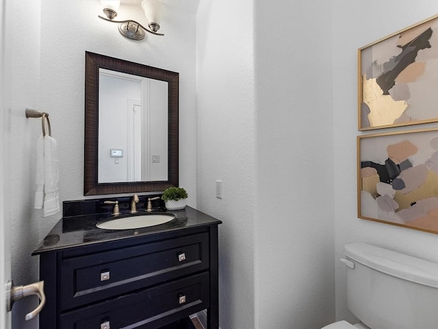 bathroom with toilet and vanity