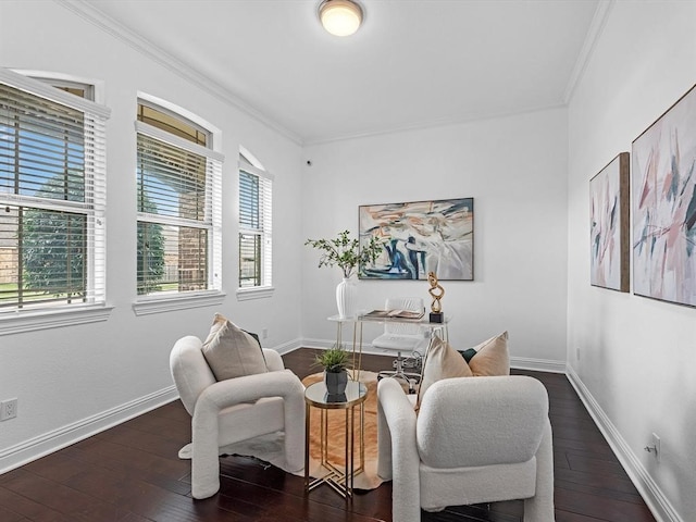 sitting room featuring ornamental molding and dark hardwood / wood-style floors