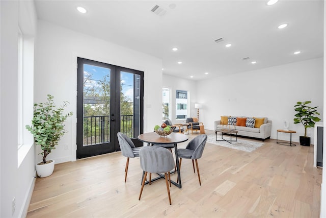 dining room with french doors, light wood-style flooring, and recessed lighting