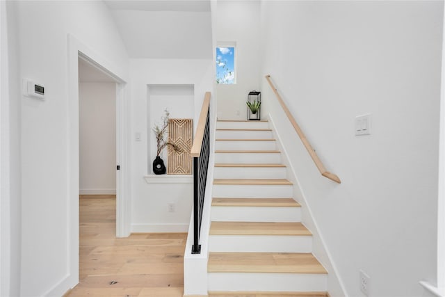 stairs featuring baseboards and wood finished floors