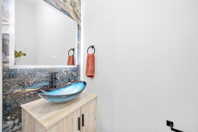 bathroom with decorative backsplash and vanity