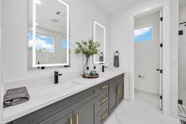 full bathroom with marble finish floor, a wealth of natural light, a sink, and visible vents