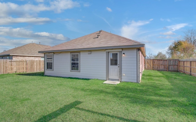 back of house with a lawn