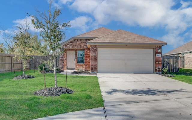 view of front of property featuring a front yard and a garage