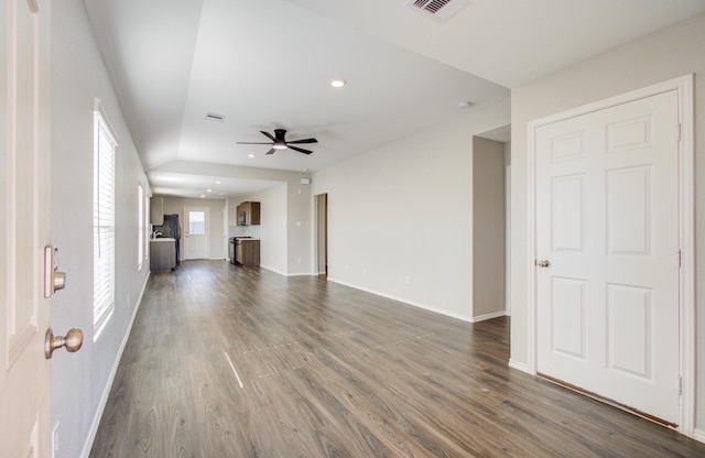 unfurnished living room featuring ceiling fan and dark hardwood / wood-style flooring