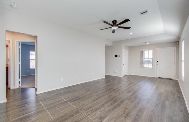 unfurnished living room with ceiling fan, dark hardwood / wood-style flooring, and vaulted ceiling