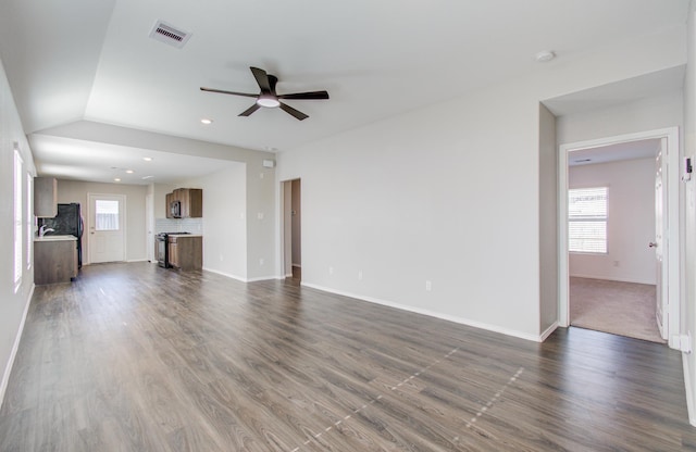 unfurnished living room with ceiling fan, dark hardwood / wood-style flooring, and lofted ceiling