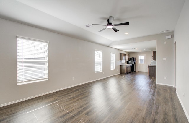 unfurnished living room with ceiling fan and dark wood-type flooring