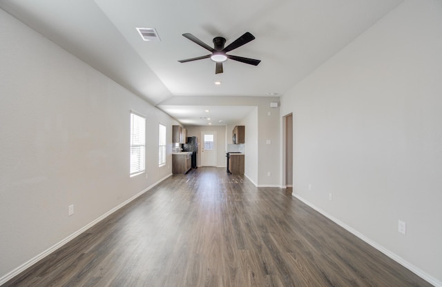 unfurnished living room featuring ceiling fan and dark hardwood / wood-style flooring