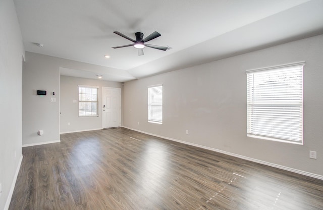 spare room with ceiling fan, lofted ceiling, and dark wood-type flooring