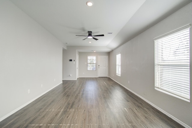 empty room featuring ceiling fan and dark wood-type flooring