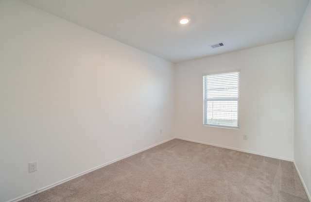 unfurnished room with light colored carpet