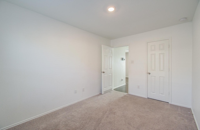 unfurnished bedroom featuring light colored carpet