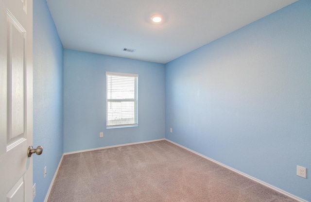 empty room with light colored carpet