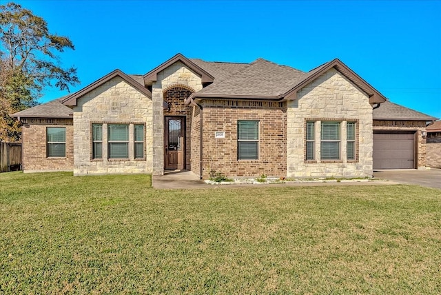 view of front of house featuring a front yard and a garage