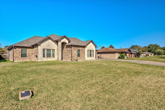 french country home featuring a front lawn