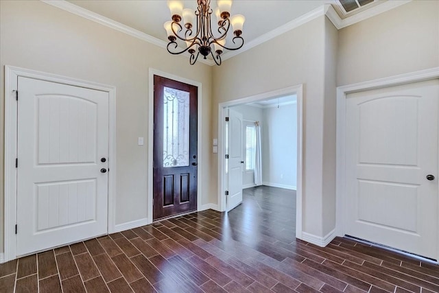 entrance foyer with ornamental molding and an inviting chandelier